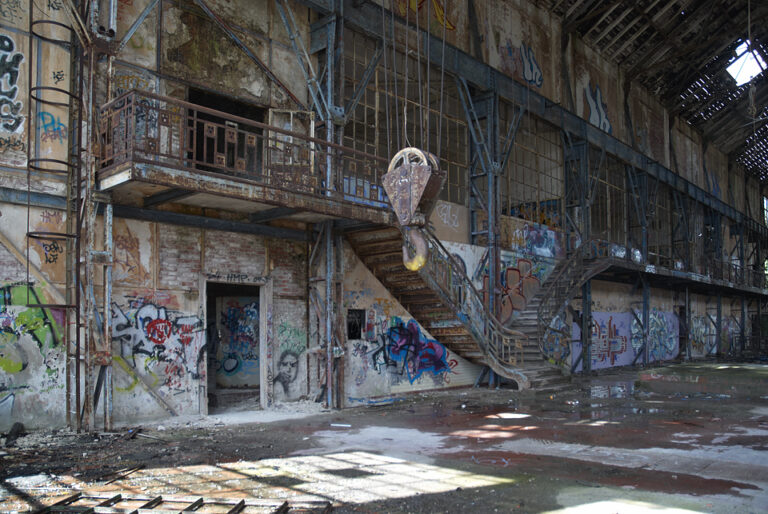 Innenansicht der Südzentrale mit sichtlichem Verfall, Graffitis und Pfützen